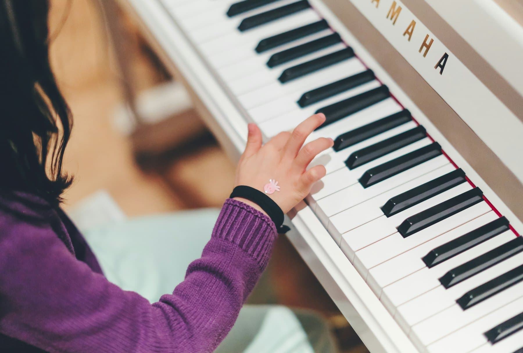 A pianist mid-lesson at a grand piano